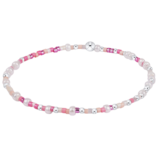Bracelet with pink and white beads on a white background