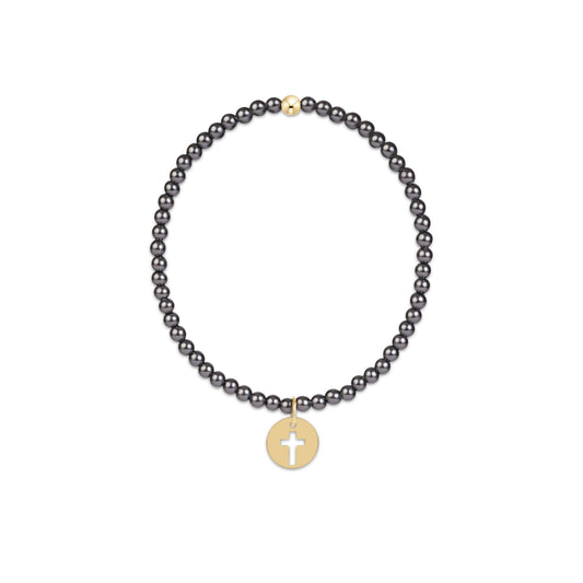 A beaded necklace featuring small, dark gray round beads and a gold-toned circular pendant with a white cross, displayed on a clean white background.