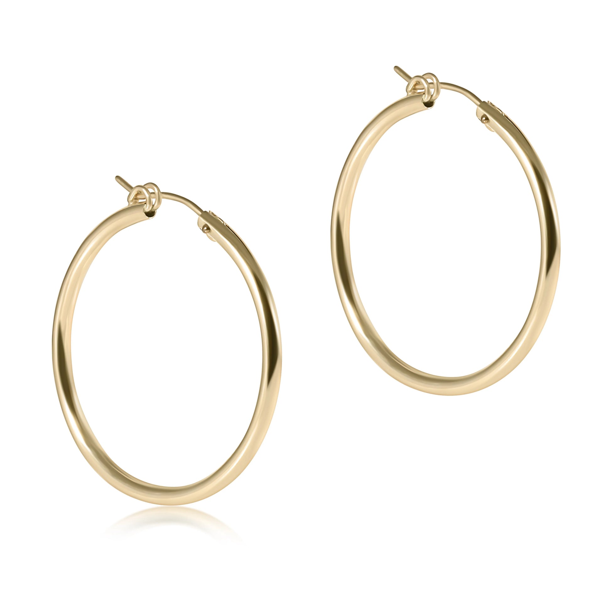 Gold hoop earrings on a white background