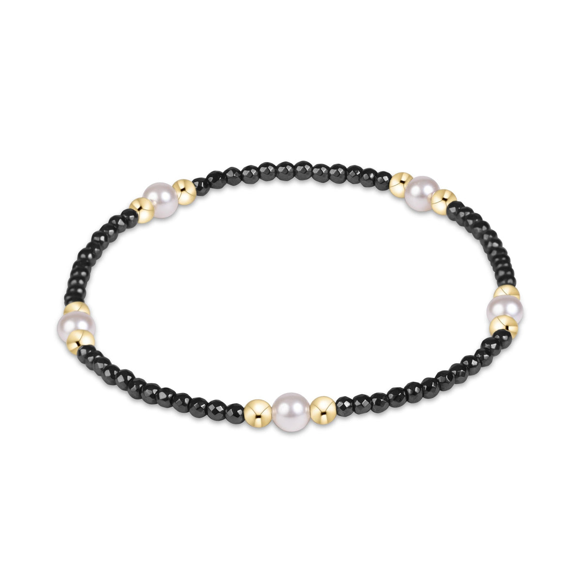 A beaded stretch bracelet featuring small black beads, larger white pearls, and polished gold spacer beads.