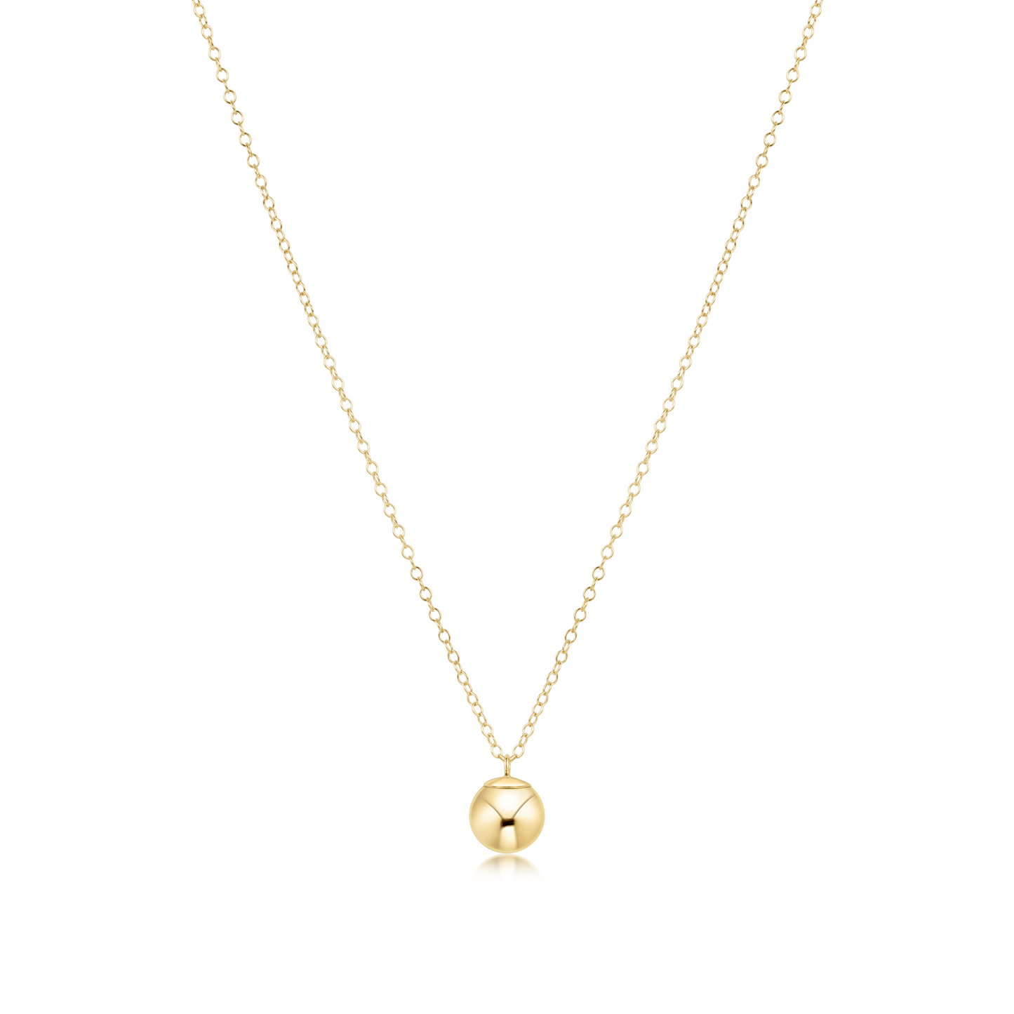 Gold necklace with a round bead charm on a white background