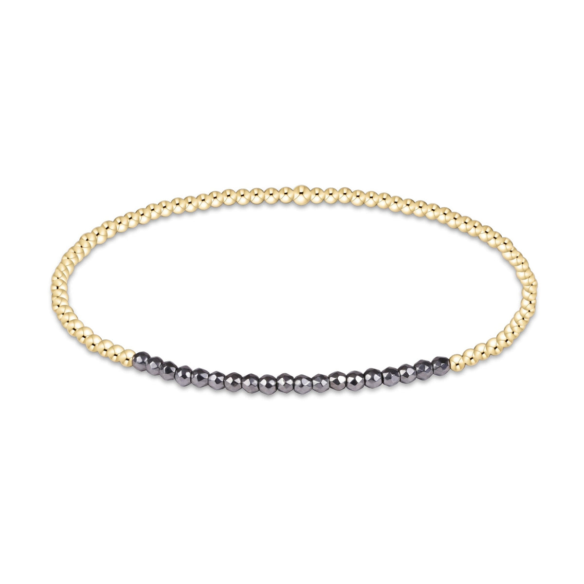 A delicate beaded stretch bracelet featuring a dual-tone design with one half in polished yellow gold and the other half in dark gray, shown on a plain white background.