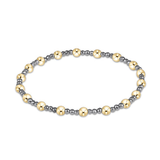 A beaded stretch bracelet featuring alternating polished gold and matte gray metallic beads, displayed on a clean white background.