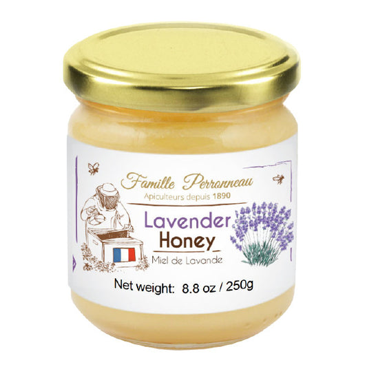Jar of lavender honey with a gold lid on a white background