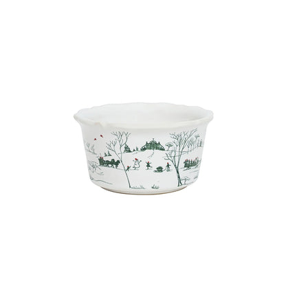 A small, white ramekin with a green, holiday toile pattern with red bird details.