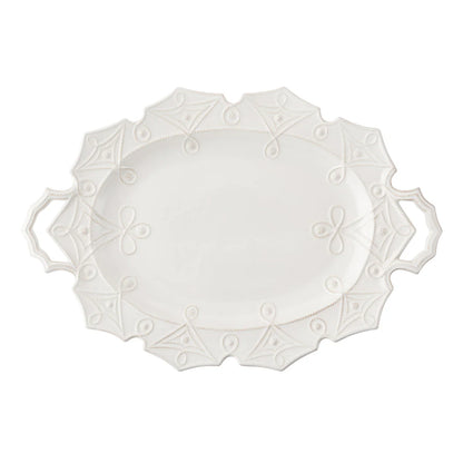 White decorative plate with intricate patterns on a white background