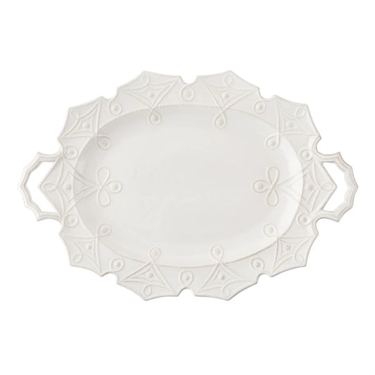 White decorative plate with intricate patterns on a white background