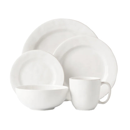 White ceramic dinnerware set on a white background