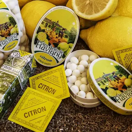 Vintage lemon candy tins and lemons on a rustic background
