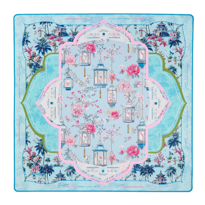 Decorative tablecloth with floral and lantern design on a blue background