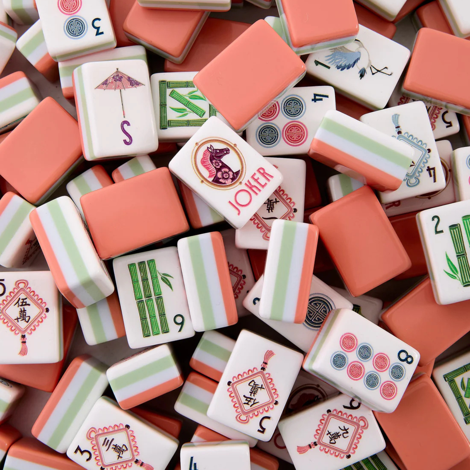 Assorted mahjong tiles with various designs and numbers.