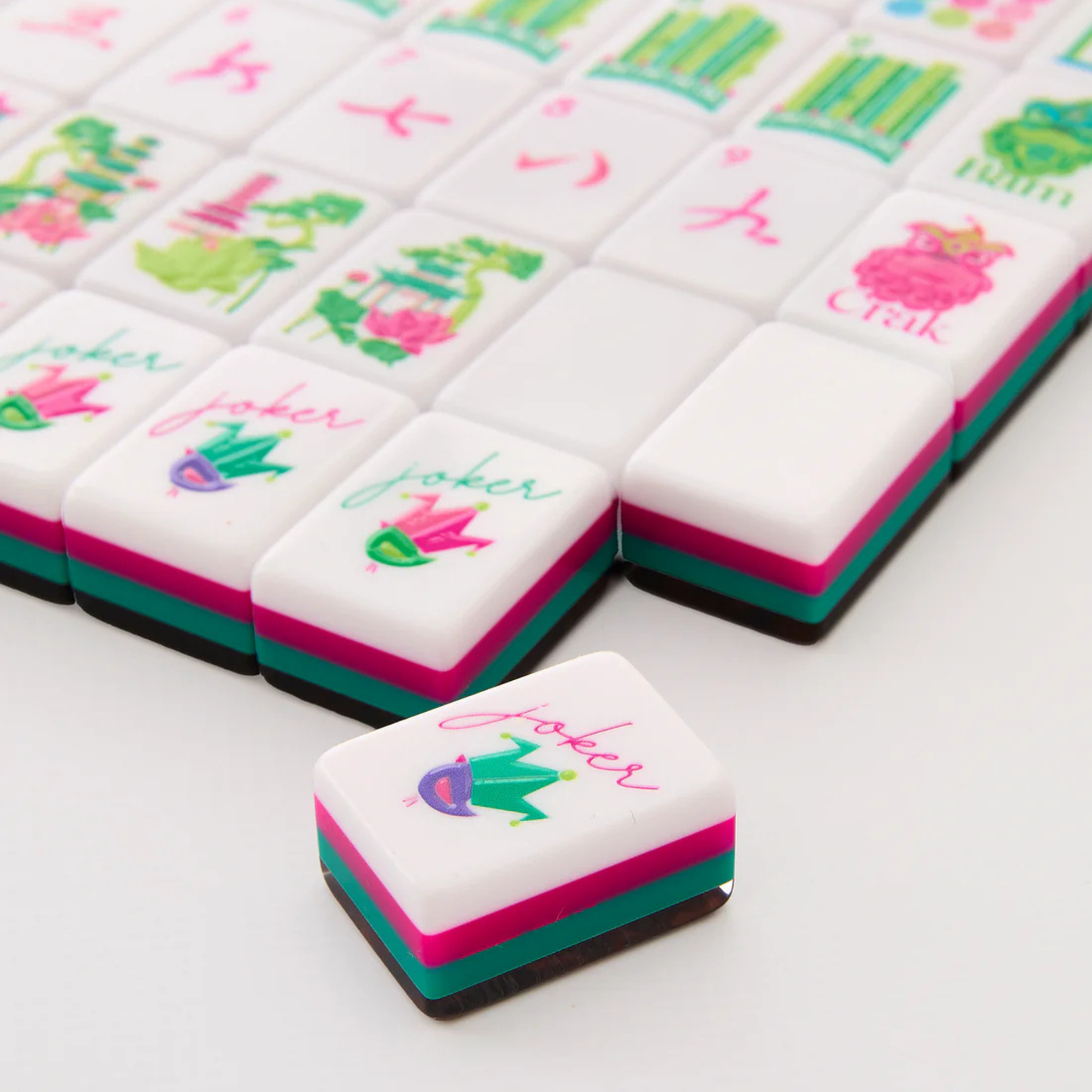 Colorful mahjong tiles with floral designs and 'joker' text on a white background