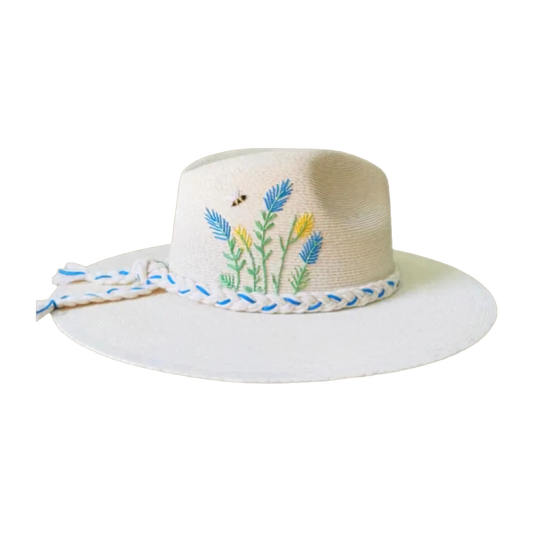 White sun hat with floral embroidery and a blue ribbon on a white background