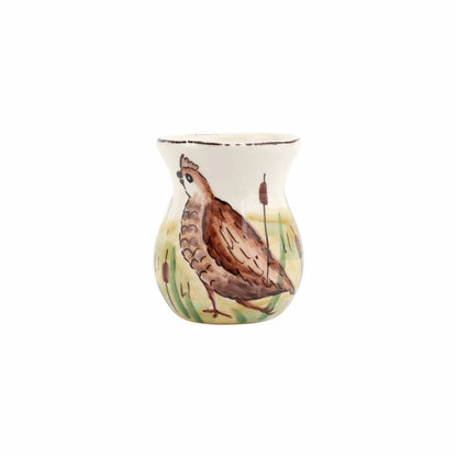 A small ceramic vase with a hand-painted brown bird.
