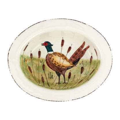 An oval ceramic serving platter featuring a hand-painted pheasant standing in a field of reeds.